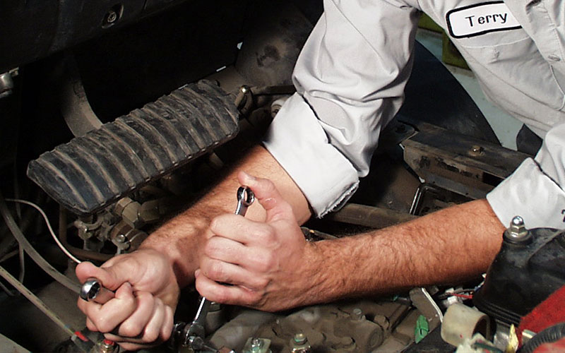 Service technician repairing forklift